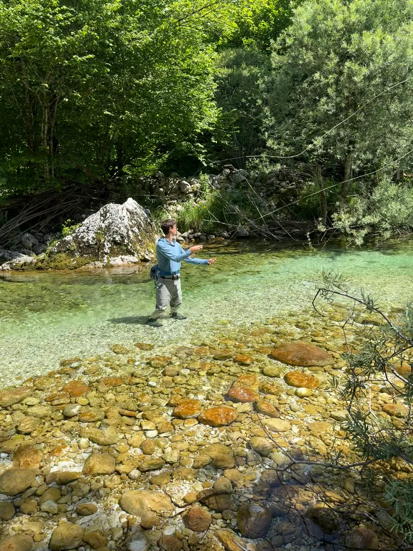 Casting into a gin-clear pool of the Soča over golden stones