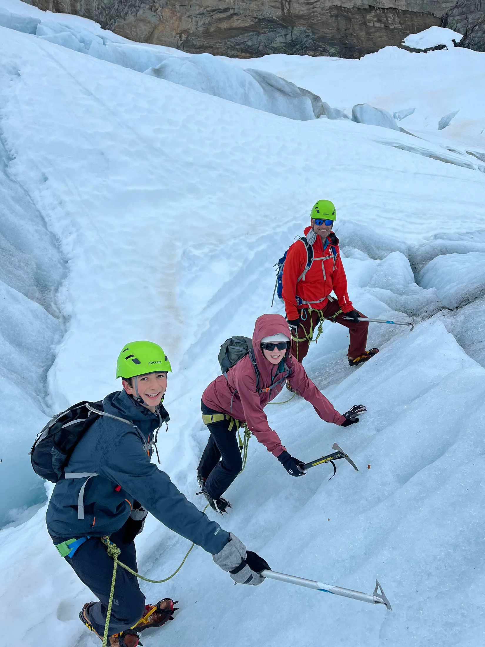 Three climbers with ice axes crossing the Jostedalsbreen glacier in Norway