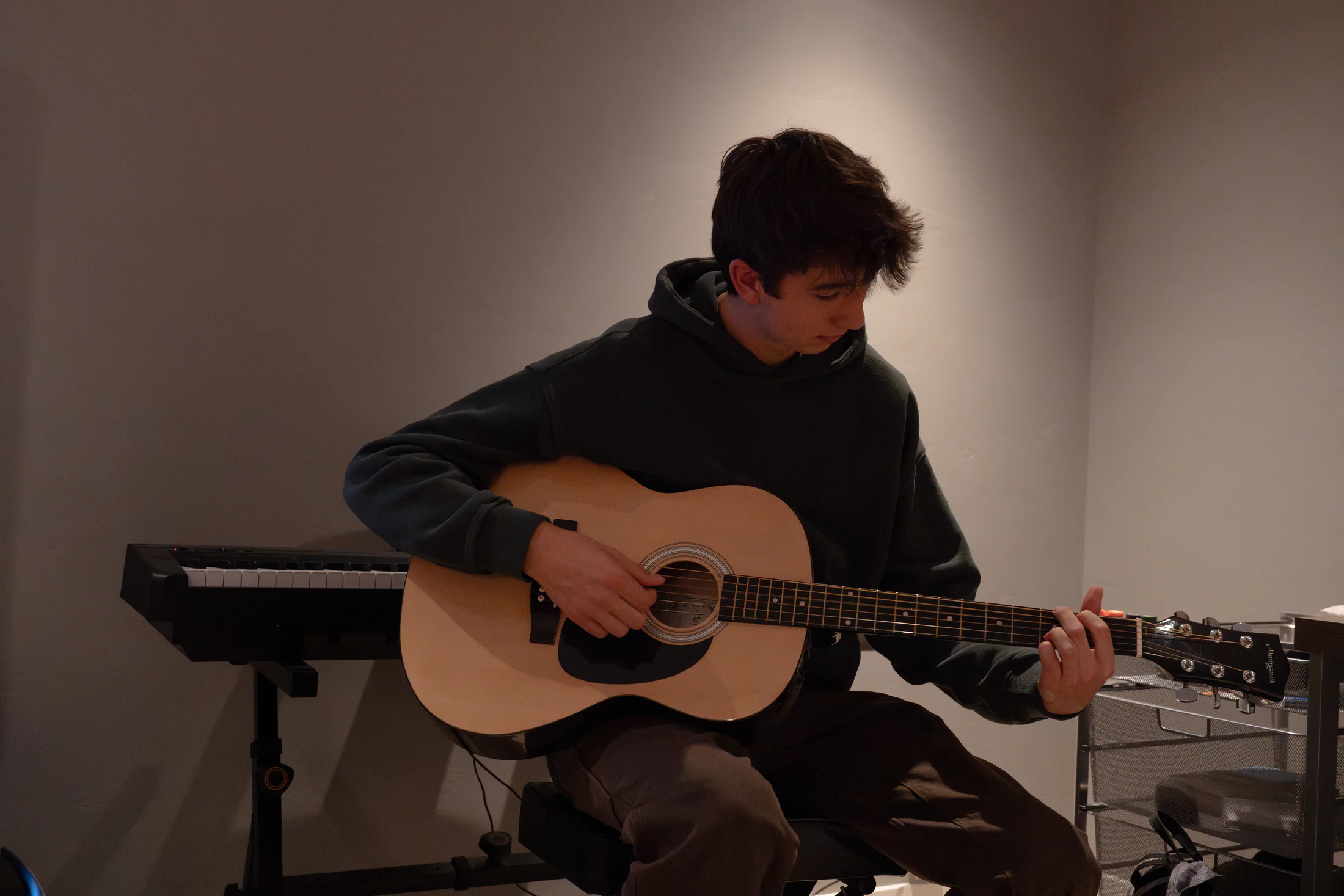 Judah playing guitar in a quiet room