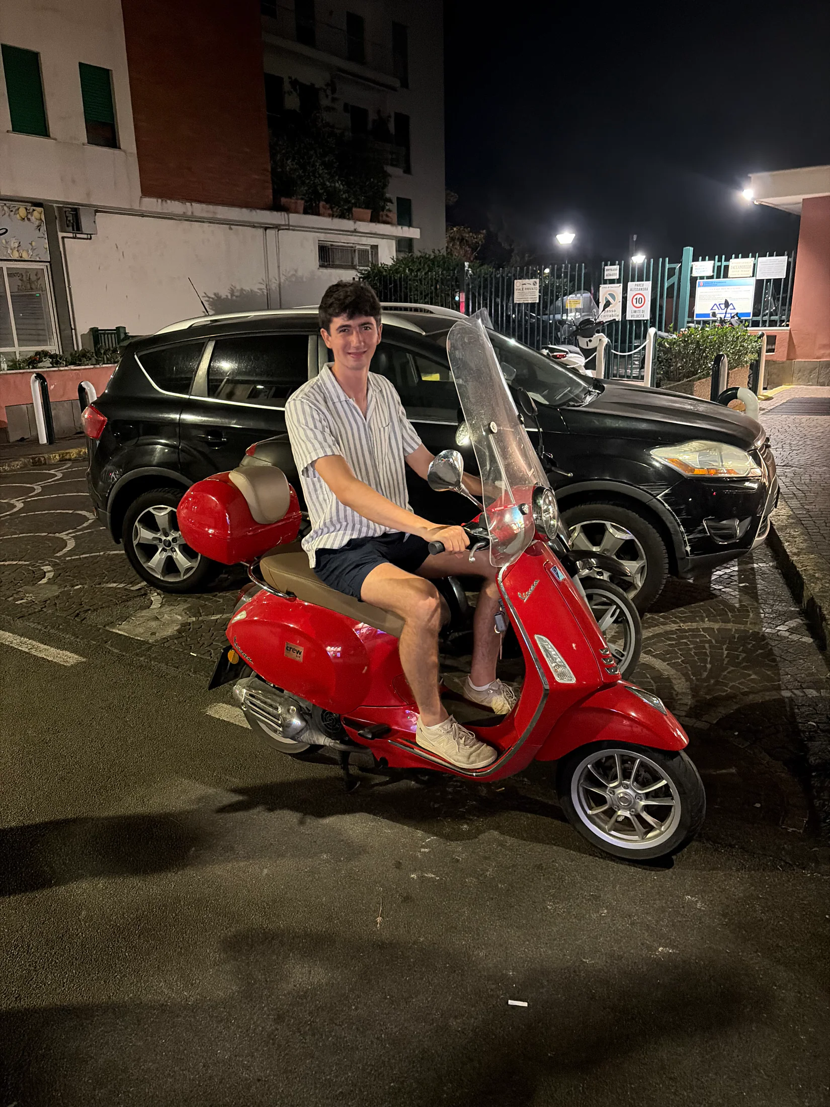 Judah on a red Vespa at night in Sorrento